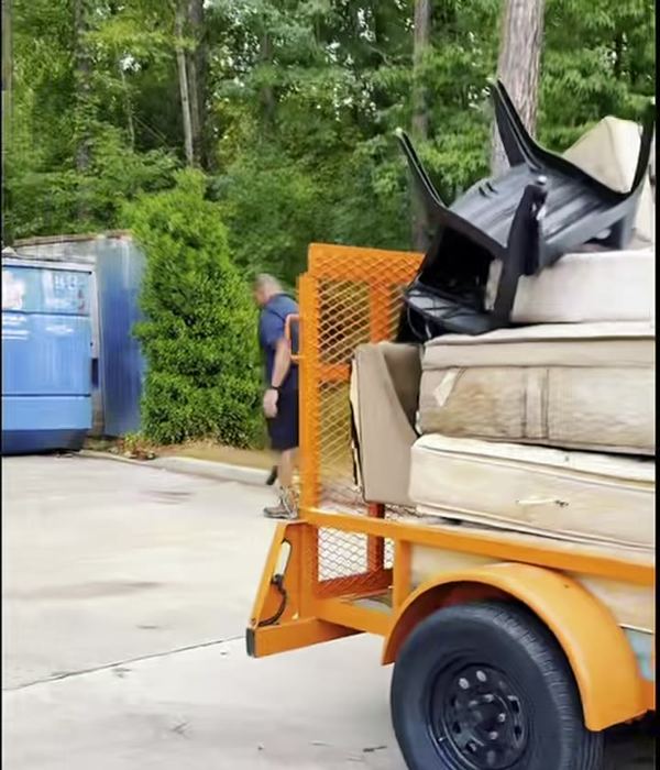 Trailer stacked with mattresses and furniture