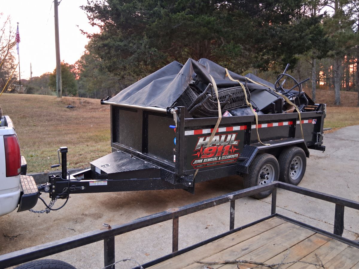 Haul 911 dump trailer loaded with patio furniture and tarped